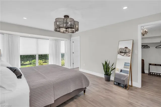 a bedroom with a large bed and a window