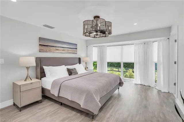 a bedroom with a large bed and a window