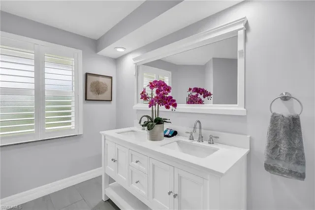a bathroom with a sink vanity and a mirror
