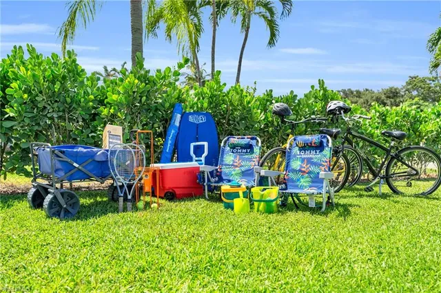 a wooden bench sitting in the grass near a house
