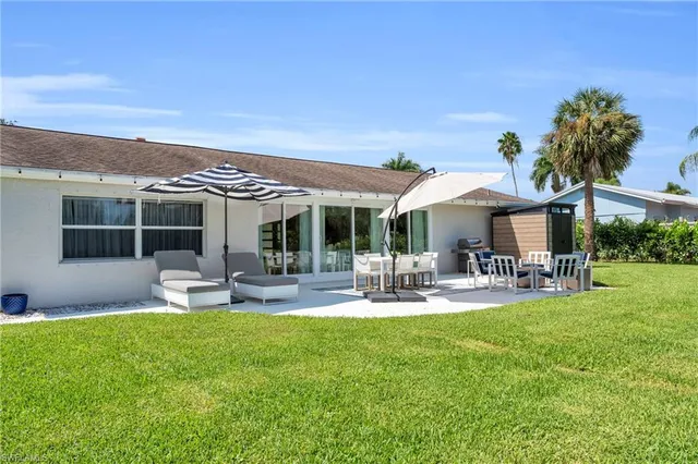a front view of a house with garden and patio