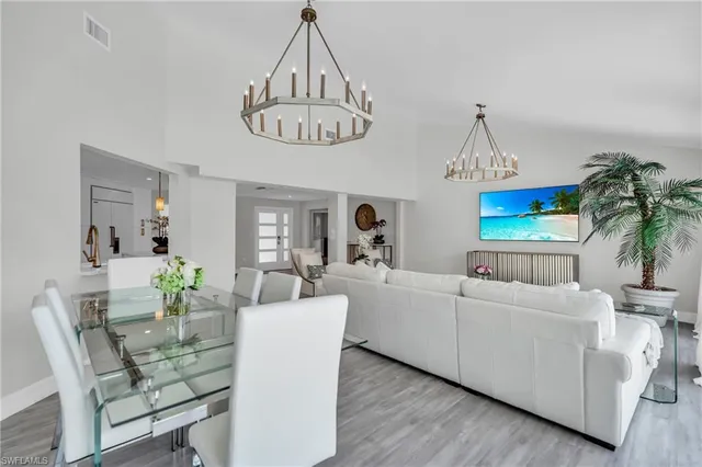 a view of a dining room with furniture wooden floor and a chandelier