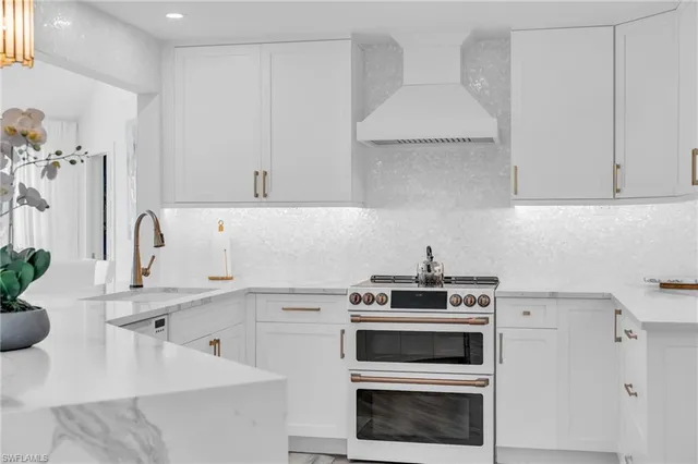 a kitchen with appliances a sink and cabinets