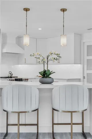 a kitchen with cabinets table and chairs
