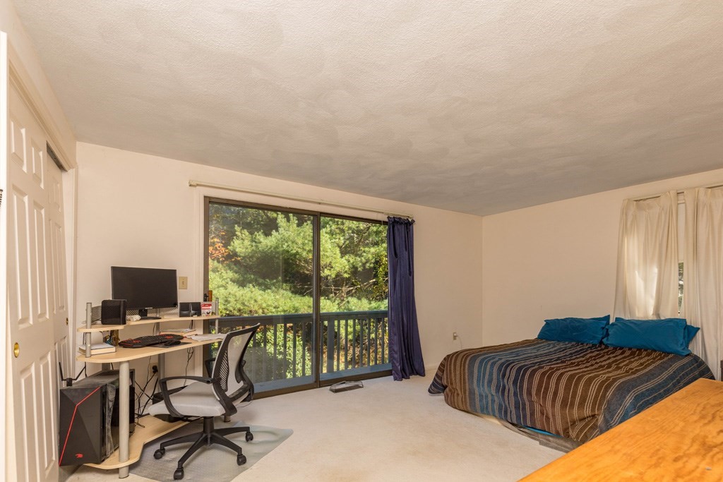 14 Deer Path, Unit 6 Maynard, MA 01754 - Photo 7 of 20 a bedroom with a bed and a desk