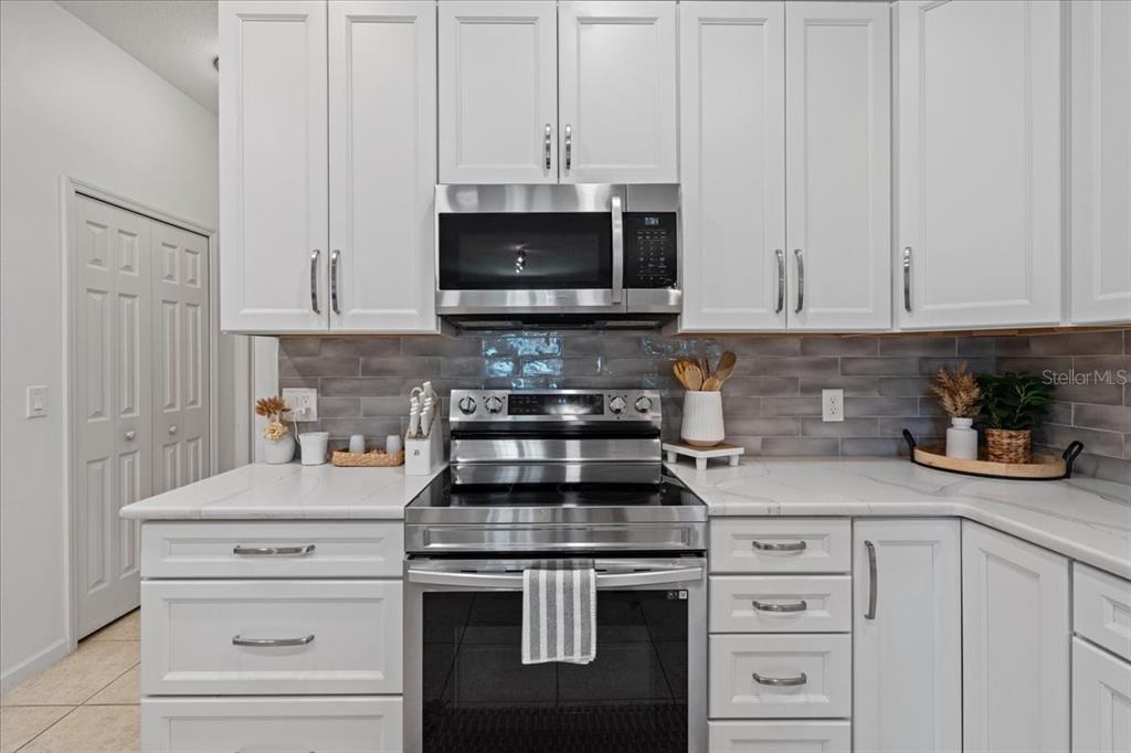 3271 Titanic Circle, Unit 39 Indialantic, FL 32903 - Photo 15 of 60 a kitchen with white cabinets and appliances