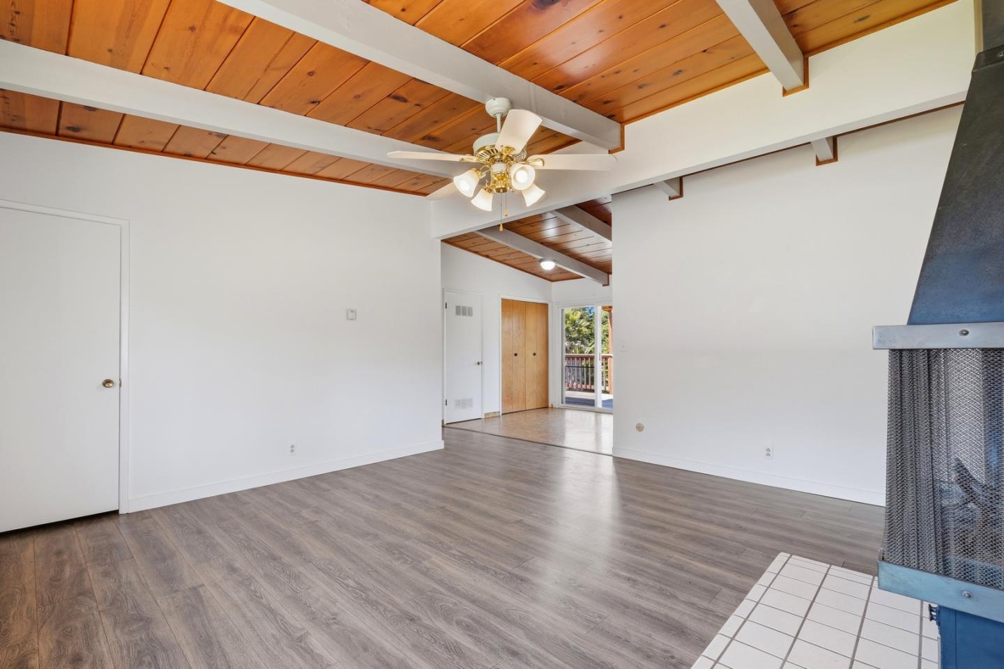 215 Manfre Road Watsonville, CA 95076 - Photo 7 of 36 a view of an empty room with wooden floor and a window