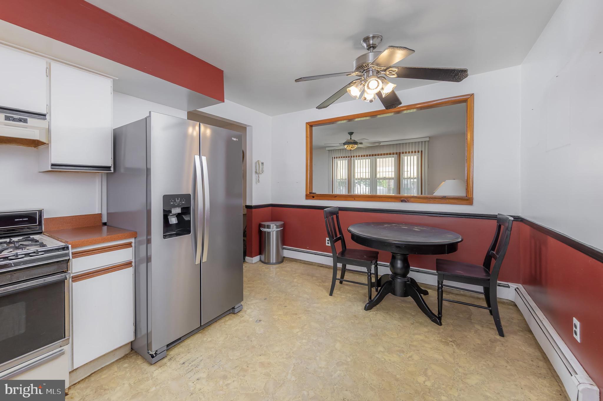 222 Nicholson Road Mount Ephraim, NJ 08059 - Photo 3 of 15 a kitchen with stainless steel appliances dining table and chairs
