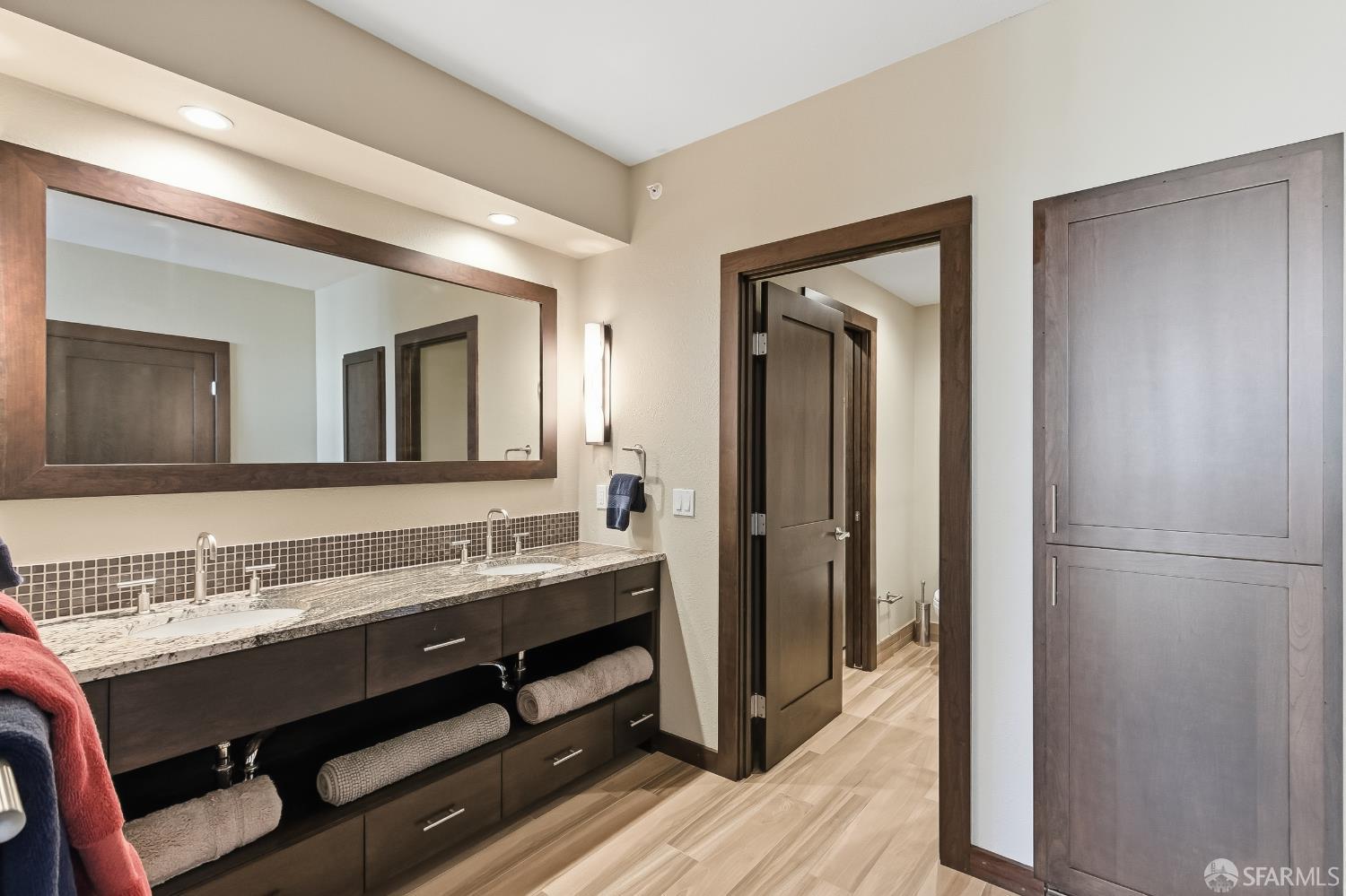 88 King Street, Unit 907 San Francisco, CA 94107 - Photo 22 of 51 a bathroom with a double vanity sink and a mirror