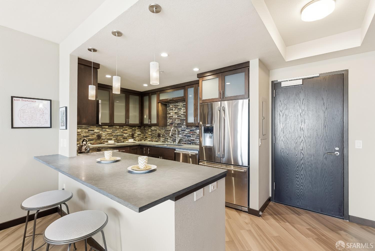 88 King Street, Unit 907 San Francisco, CA 94107 - Photo 4 of 51 a kitchen with a sink refrigerator and dining table