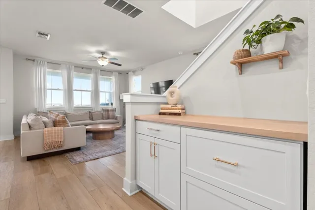 a kitchen with stainless steel appliances granite countertop a stove a sink a microwave a refrigerator and cabinets