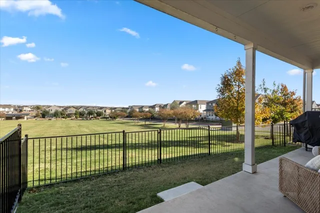 a view of a porch with couches and floor to ceiling window
