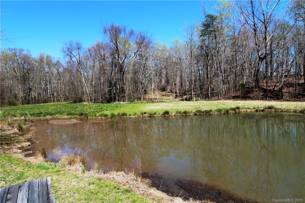 934 Beamguard Road Clover, SC 29710 - Photo 33 of 35 a view of a lake with a yard and trees in the background