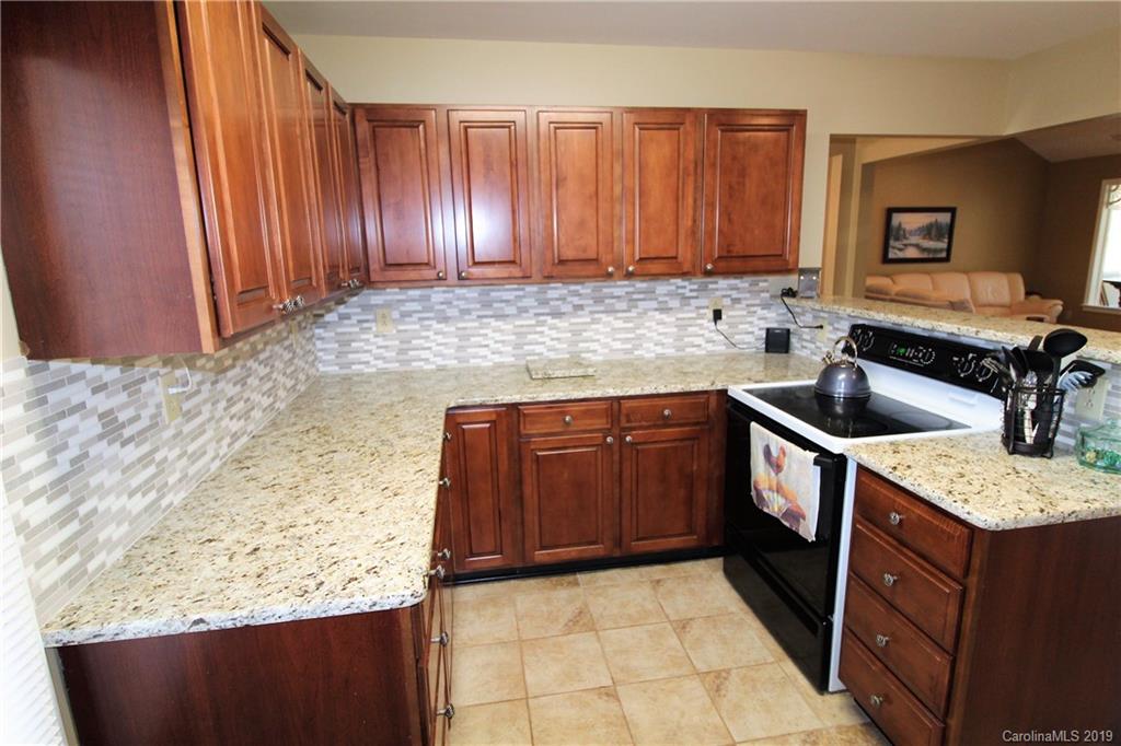 934 Beamguard Road Clover, SC 29710 - Photo 7 of 35 a kitchen with granite countertop a sink a stove and cabinets