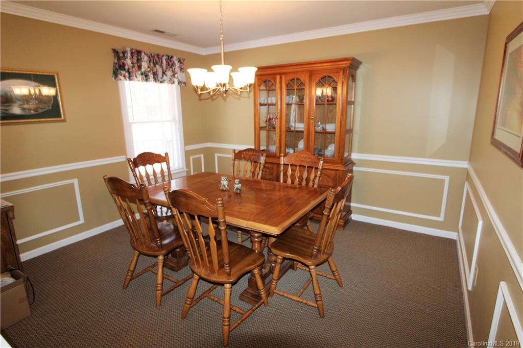 934 Beamguard Road Clover, SC 29710 - Photo 10 of 35 a view of a dining room with furniture wooden floor and chandelier