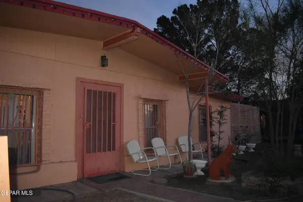 a view of backyard with outdoor seating and plants