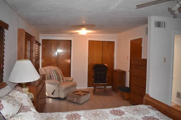 a room with lots of flowers and a chandelier