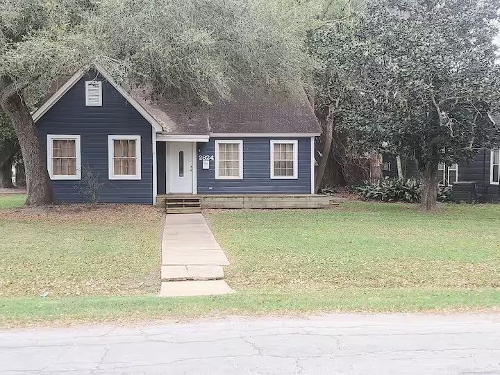 2824 5th Street Bay City, TX 77414 - Photo 1 of 17 a front view of a house with a garden