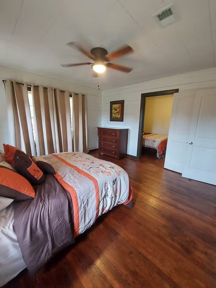 2824 5th Street Bay City, TX 77414 - Photo 14 of 17 a bedroom with a bed and wooden floor