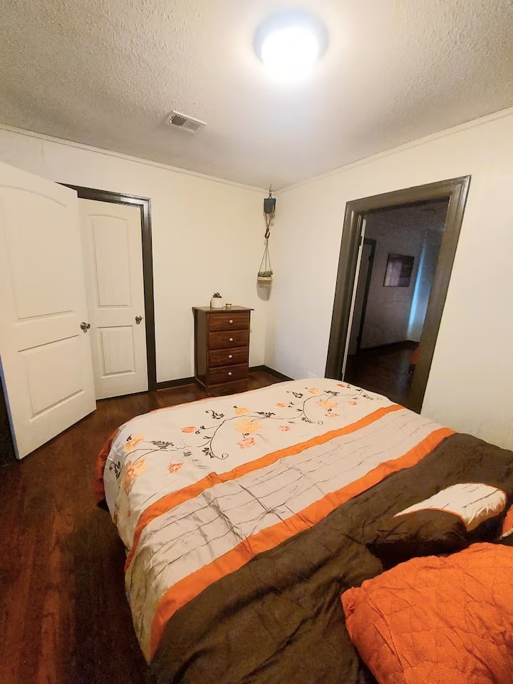 2824 5th Street Bay City, TX 77414 - Photo 17 of 17 a bedroom with a bed and wooden floor