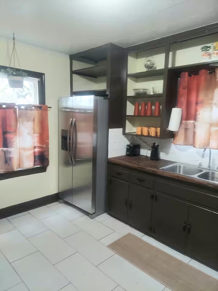 2824 5th Street Bay City, TX 77414 - Photo 3 of 17 a kitchen with stainless steel appliances kitchen island granite countertop a refrigerator and a sink