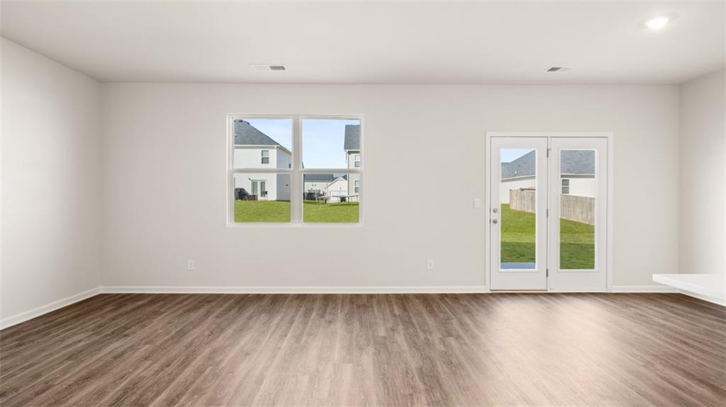 214 Cattle Drive Perry, GA 31069 - Photo 15 of 39 an empty room with wooden floor and window