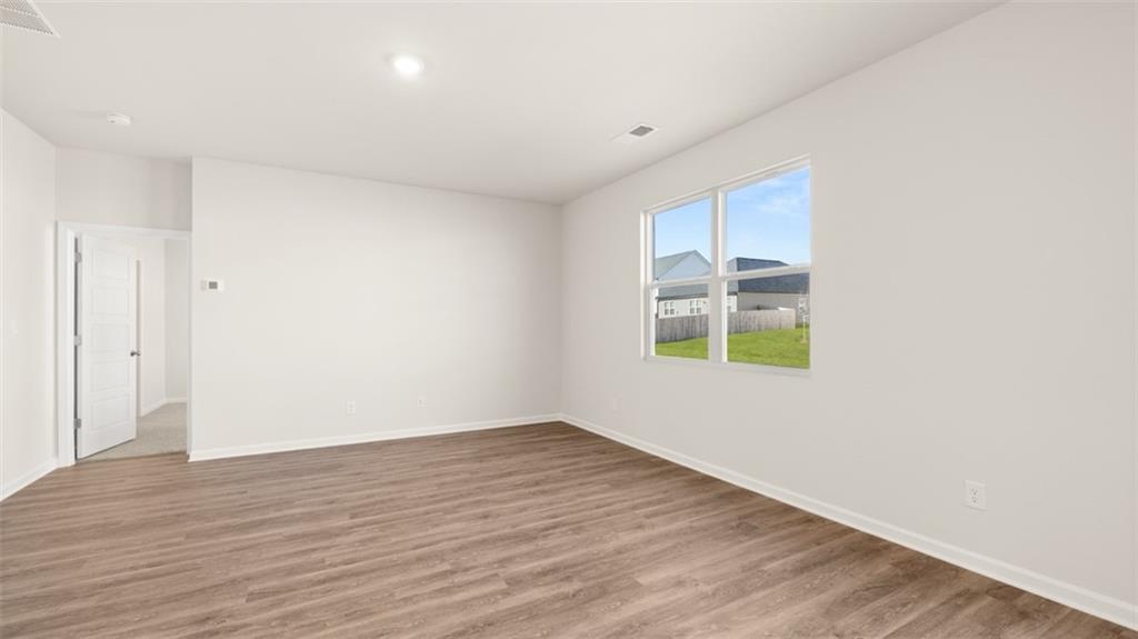 214 Cattle Drive Perry, GA 31069 - Photo 16 of 39 a view of an empty room with wooden floor and a window