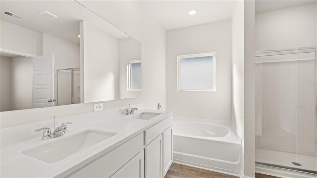 214 Cattle Drive Perry, GA 31069 - Photo 24 of 39 a bathroom with a bathtub shower sink and a mirror
