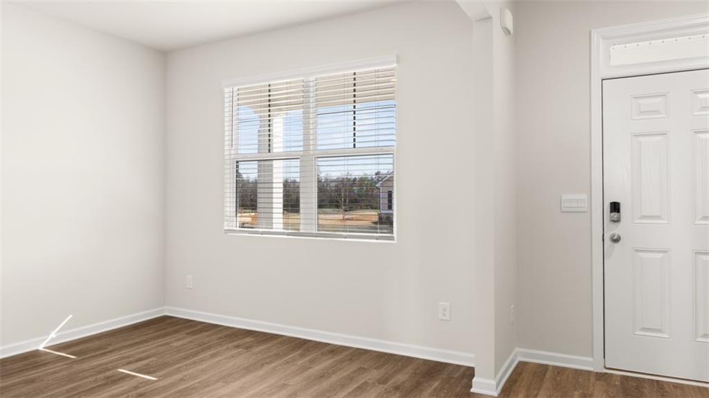 214 Cattle Drive Perry, GA 31069 - Photo 5 of 39 a view of an empty room with wooden floor and a window