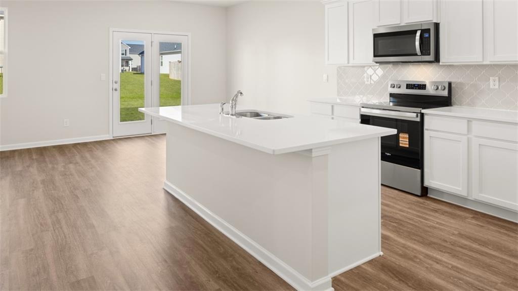 214 Cattle Drive Perry, GA 31069 - Photo 6 of 39 a kitchen with a sink cabinets and wooden floor