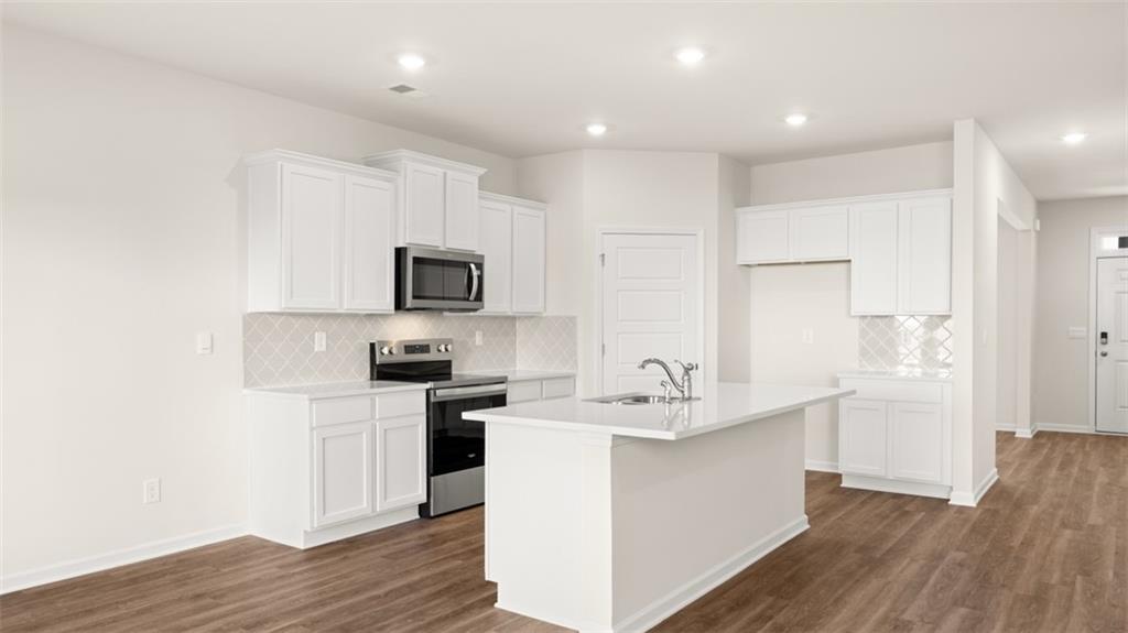 214 Cattle Drive Perry, GA 31069 - Photo 8 of 39 a kitchen with a sink stainless steel appliances and white cabinets
