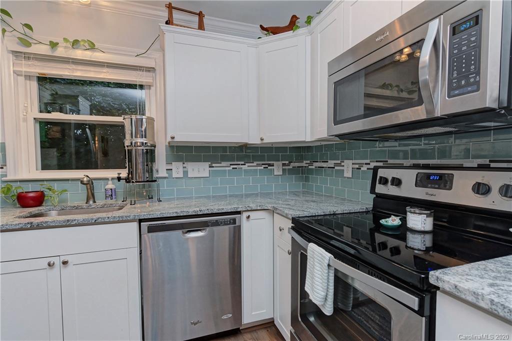 7407 Watercrest Road Charlotte, NC 28210 - Photo 12 of 42 a kitchen with stainless steel appliances granite countertop a stove and a microwave