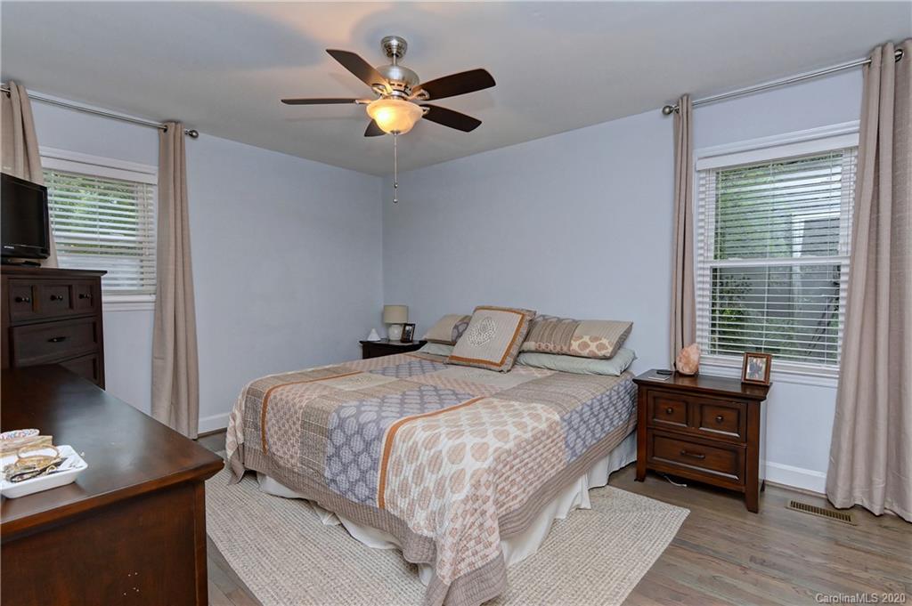 7407 Watercrest Road Charlotte, NC 28210 - Photo 16 of 42 a bedroom with a bed and a flat screen tv
