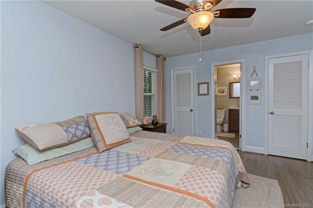 7407 Watercrest Road Charlotte, NC 28210 - Photo 17 of 42 a bedroom with a bed and a chandelier