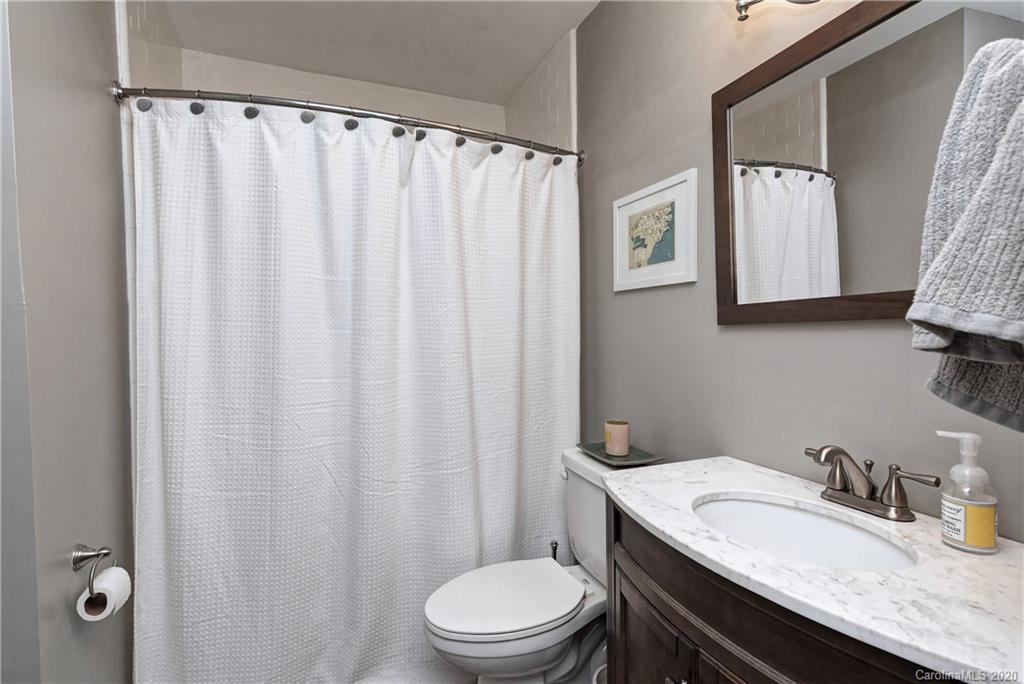 7407 Watercrest Road Charlotte, NC 28210 - Photo 18 of 42 a bathroom with a granite countertop sink toilet and a mirror