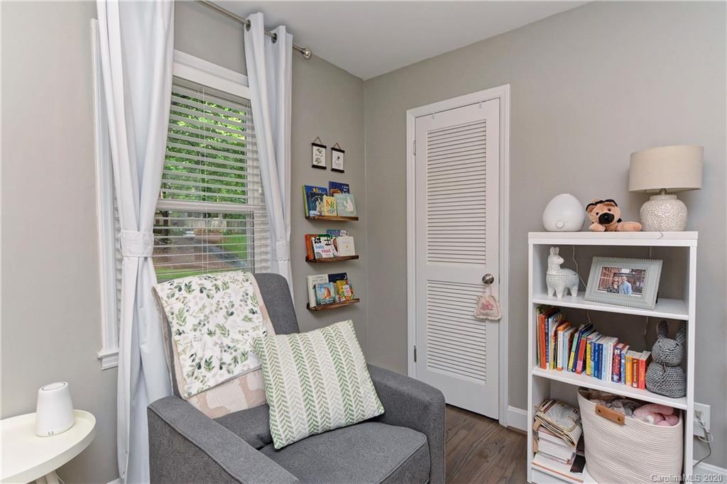 7407 Watercrest Road Charlotte, NC 28210 - Photo 22 of 42 a living room with furniture and a book shelf