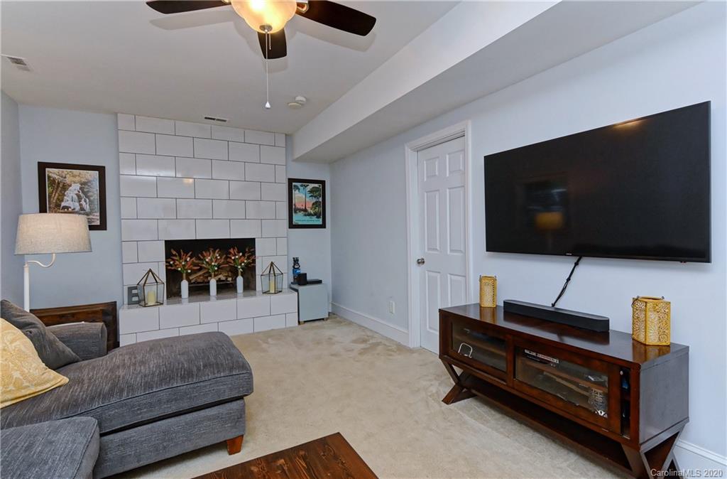 7407 Watercrest Road Charlotte, NC 28210 - Photo 24 of 42 a living room with furniture and a flat screen tv