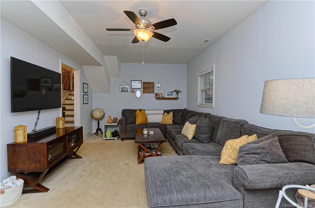 7407 Watercrest Road Charlotte, NC 28210 - Photo 26 of 42 a living room with furniture and a flat screen tv