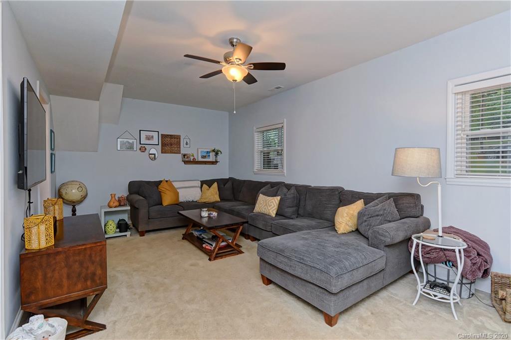 7407 Watercrest Road Charlotte, NC 28210 - Photo 27 of 42 a living room with furniture and chandelier