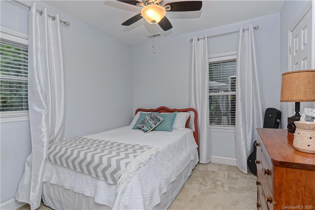 7407 Watercrest Road Charlotte, NC 28210 - Photo 28 of 42 a bedroom with a bed and a chandelier