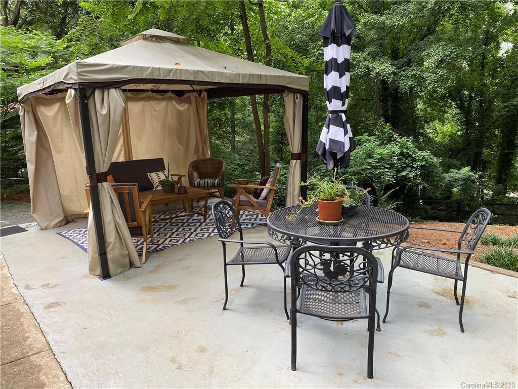 7407 Watercrest Road Charlotte, NC 28210 - Photo 31 of 42 a view of a patio with a table and chairs