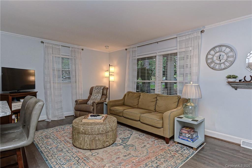7407 Watercrest Road Charlotte, NC 28210 - Photo 6 of 42 a living room with furniture a flat screen tv and a window