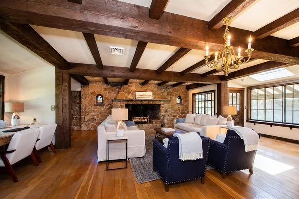 a living room with furniture a fireplace and a table