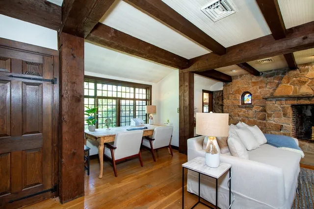 a living room with furniture a fireplace and a table