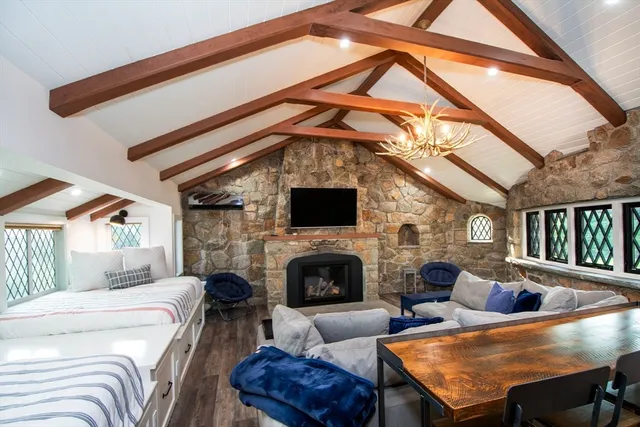 a living room with furniture a flat screen tv and a fireplace