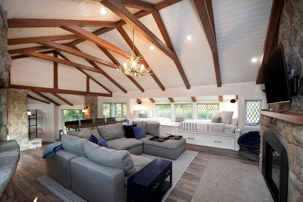 a bedroom with a large bed and wooden floor