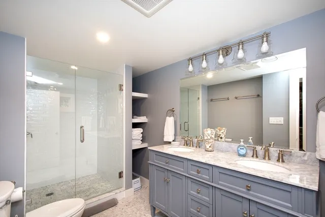 a bedroom with a bed and a large window with wooden floor