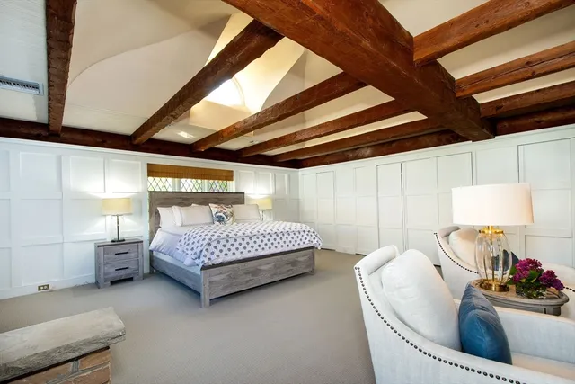 an empty room with window and fireplace