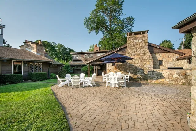 a view of a patio with couches chairs and a umbrella
