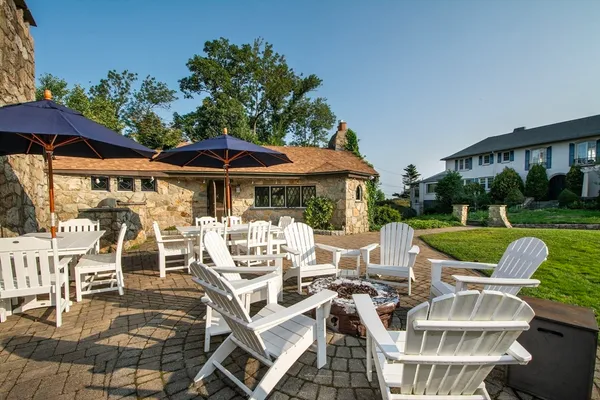 a view of a patio with table and chairs under an umbrella